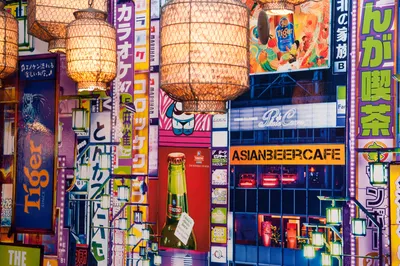 Pop-art collage wallpaper and paper lanterns in a function room at Asian Beer Cafe