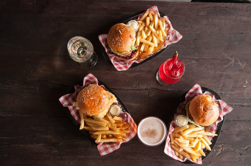 Burgers and fries in paper-lined baskets, from above