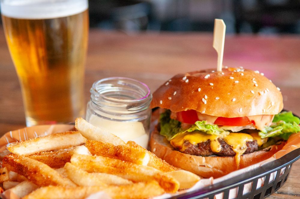 A cheeseburger, fries and a beer